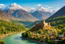 Chitral Fort with traditional houses along the river and snow-covered Hindu Kush mountains in northern Pakistan
