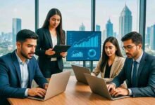 Young Pakistani entrepreneurs working with laptops in a modern office, symbolizing business growth and innovation in Pakistan.