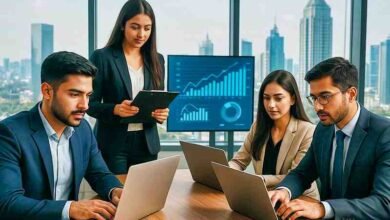 Young Pakistani entrepreneurs working with laptops in a modern office, symbolizing business growth and innovation in Pakistan.