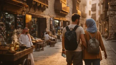 Budget travelers walking in Al-Balad, Historic Jeddah, Saudi Arabia at golden hour with local shops and a tea and dates street vendor
