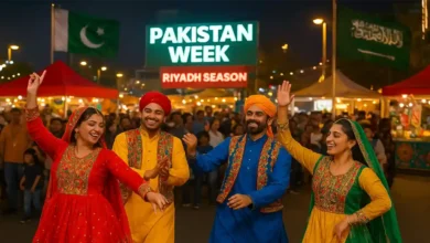 Traditional Pakistani dancers performing in vibrant cultural attire during Pakistan Week at Riyadh Season, with festival lights and crowds in the background.