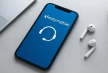 Smartphone displaying Xfinity Mobile app with customer support icons on a modern desk
