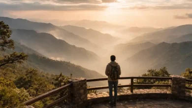Traveler at a mountain viewpoint overlooking misty Asir Mountains in Abha at sunset