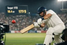 Cricketer playing a cover drive under floodlights with a packed stadium and scoreboard in the background