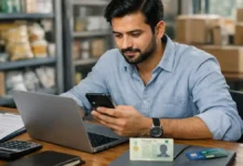 Small business owner in Punjab using a laptop and smartphone to apply online for Asaan Karobar Card 2026
