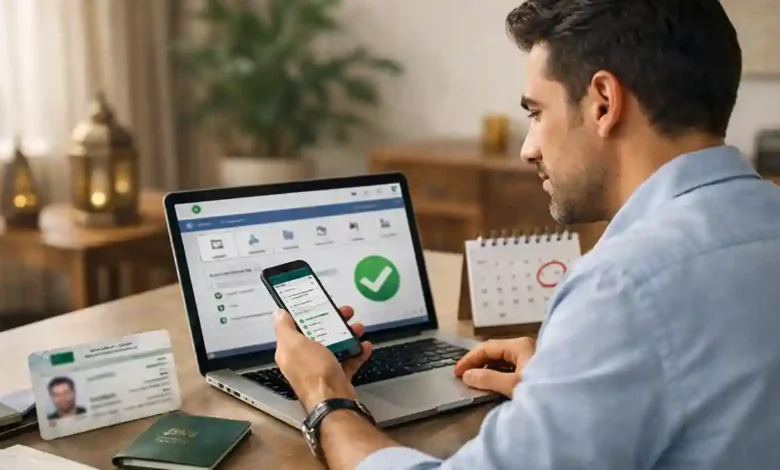 Expat in Saudi Arabia checking Iqama renewal details on Absher using a smartphone and laptop at a desk