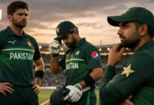 Pakistan national cricket players standing on the field in a stadium during an intense match moment, showing focus, pressure, and reflection in 2026