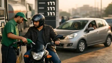 Motorcyclist refueling at a petrol station in Pakistan while a family car waits nearby, showing the daily impact of rising fuel prices.