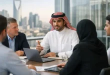 Saudi employer meeting with expat professionals in a modern Riyadh office discussing Saudization updates, hiring, and workforce planning